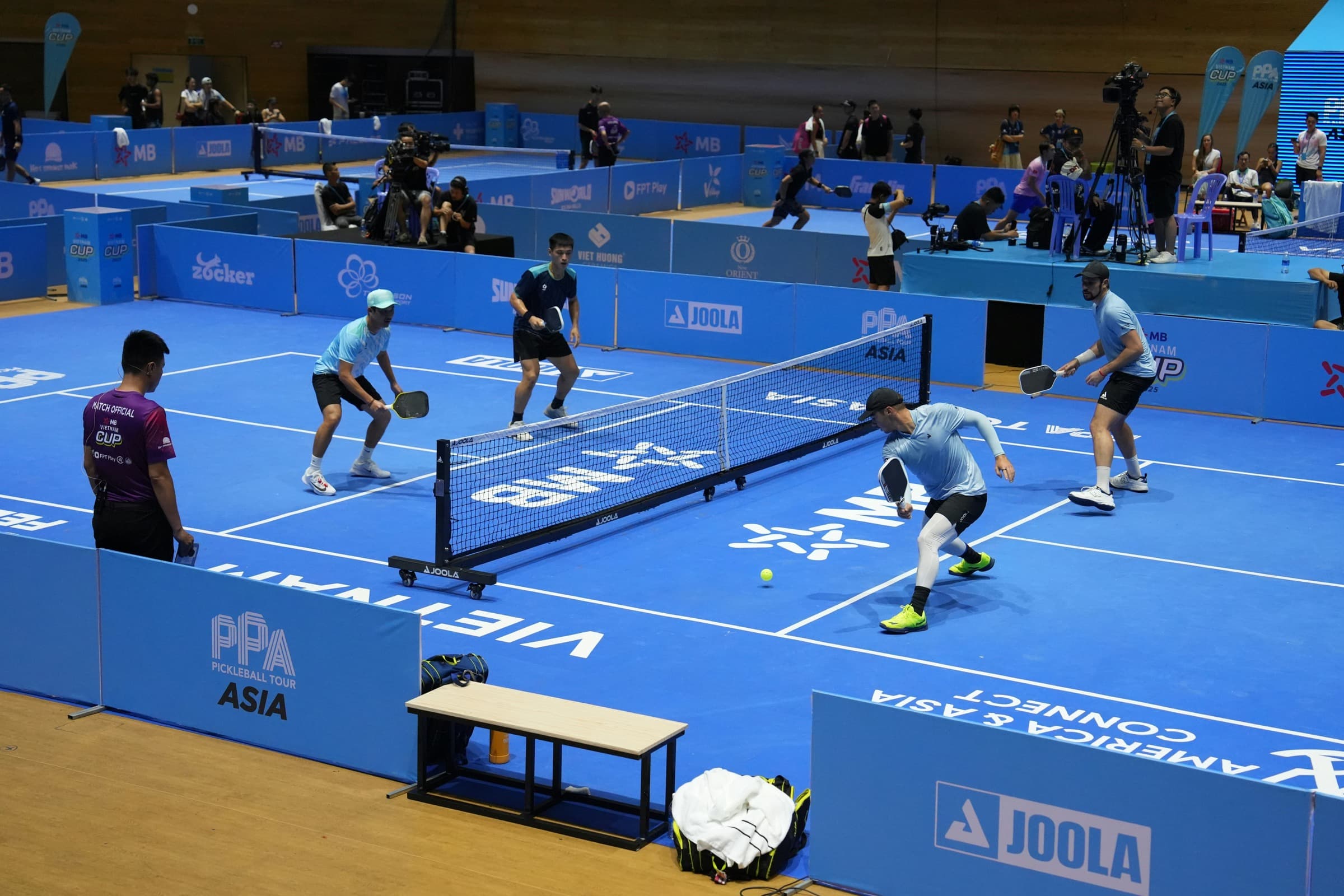 Players competing on a professionally installed pickleball court